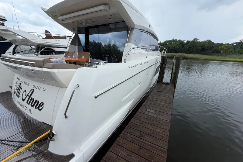 Slide: The Image of Luxury 2012 Prestige 500S yacht docked by serene waterside. - 92