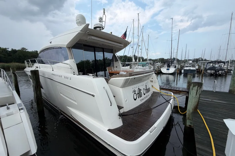 Slide: The Image of Luxury 2012 Prestige 500S yacht docked at marina under cloudy sky. - 91