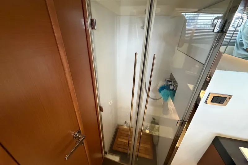 Slide: The Image of Shower area in 2012 Prestige 500S yacht with glass doors and wooden floor mat. - 62