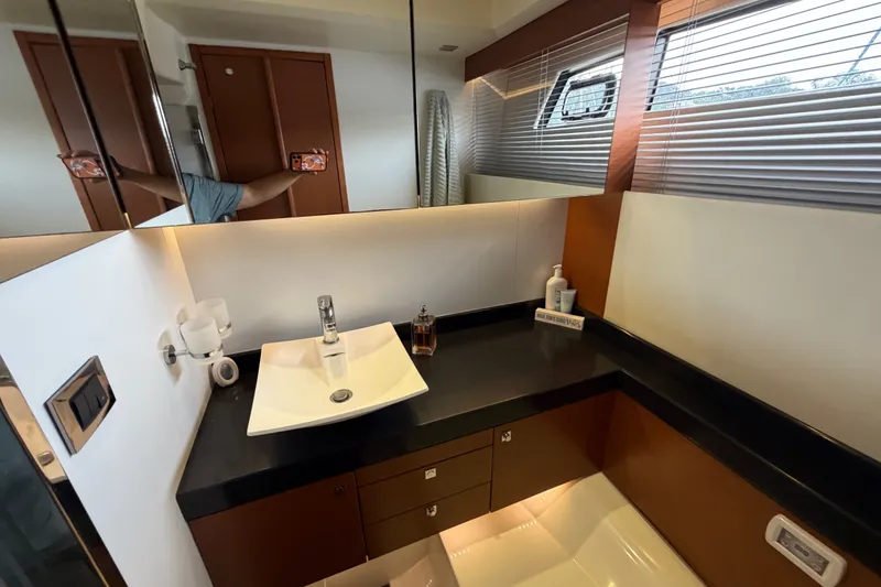 Slide: The Image of Luxurious bathroom interior of a 2012 Prestige 500S yacht, featuring modern sink and fixtures. - 59