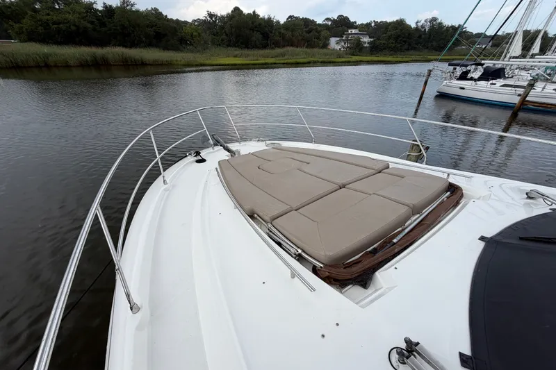 Slide: The Image of Prestige 500S 2012 yacht with sunbathing deck, docked by a serene riverside. - 89