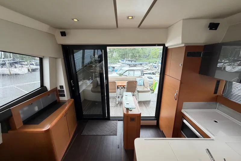 Slide: The Image of Interior view of 2012 Prestige 500S yacht, featuring modern kitchen and outdoor seating area. - 84