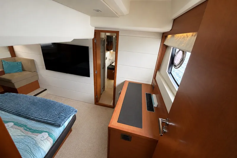 Slide: The Image of Luxurious interior of a 2012 Prestige 500S yacht with modern furnishings and a large window. - 51