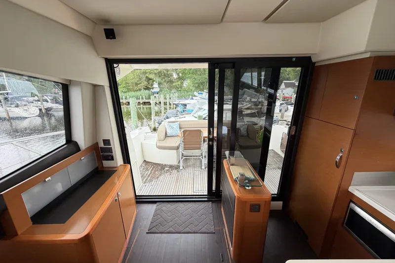 Slide: The Image of Interior view of a 2012 Prestige 500S yacht, featuring modern wood cabinetry and sliding glass doors. - 82