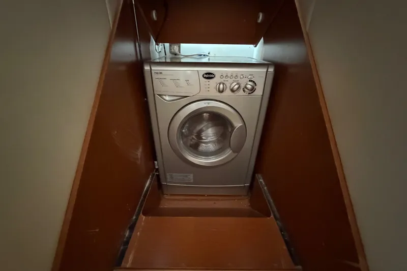 Slide: The Image of Compact washing machine in a wooden alcove on a 2012 Prestige 500S yacht. - 46