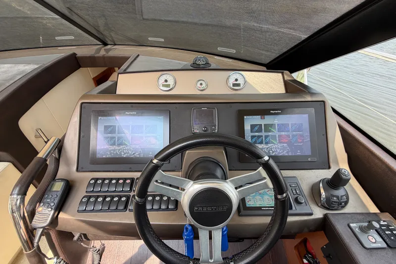 Slide: The Image of Cockpit of 2012 Prestige 500S yacht with dual navigation screens and control panel. - 22