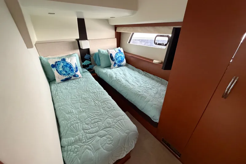 Slide: The Image of Twin beds in a 2012 Prestige 500S yacht cabin with sea-themed decor. - 39