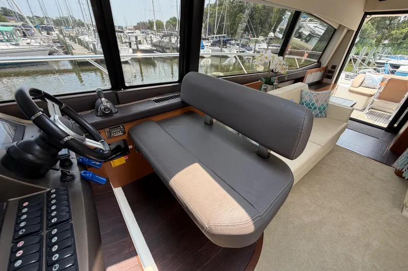 Slide: The Image of Interior of a 2012 Prestige 500S yacht with helm, seating, and marina view. - 24