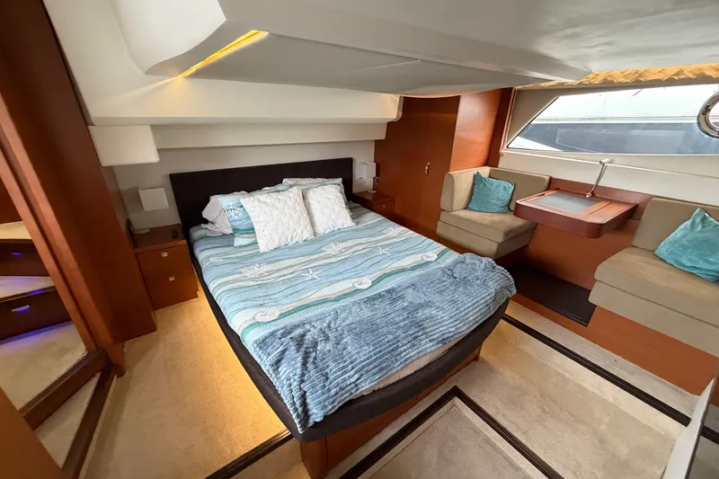 Slide: The Image of Luxurious cabin interior of a 2012 Prestige 500S yacht with cozy bedding and seating. - 64