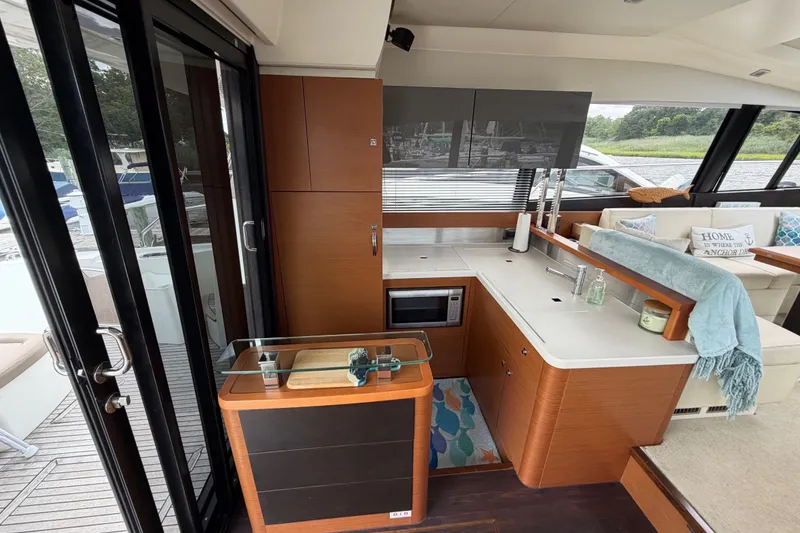 Slide: The Image of Luxurious interior of a 2012 Prestige 500S yacht featuring a modern kitchen and cozy seating area. - 12