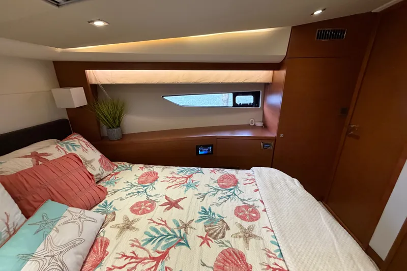 Slide: The Image of Luxurious cabin interior of a 2012 Prestige 500S yacht with nautical-themed bedding. - 75