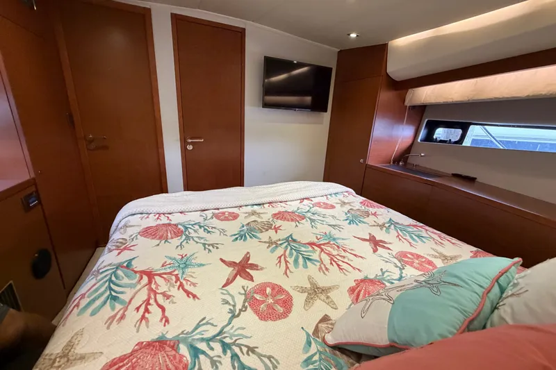 Slide: The Image of Luxurious bedroom interior of 2012 Prestige 500S yacht with nautical-themed bedding. - 69