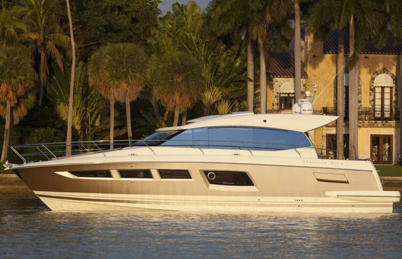 The Image of Manufacturer Provided Image: 2013 Prestige 500 S yacht cruising near a luxurious waterfront property. - 1