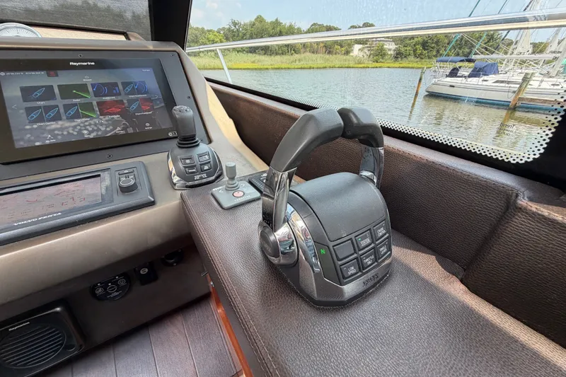 Slide: The Image of Control panel of a 2012 Prestige 500S yacht with navigation display and throttle. - 23