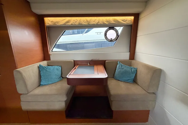 Slide: The Image of Luxurious interior of 2012 Prestige 500S yacht with cozy seating and elegant window view. - 54