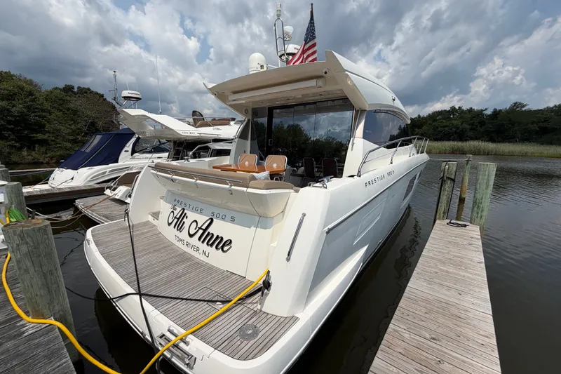 Slide: The Image of Luxury 2012 Prestige 500S yacht docked, featuring sleek design and spacious deck. - 5