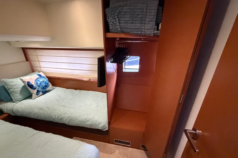 Slide: The Image of Cozy cabin interior of 2012 Prestige 500S yacht with twin beds and closet. - 76