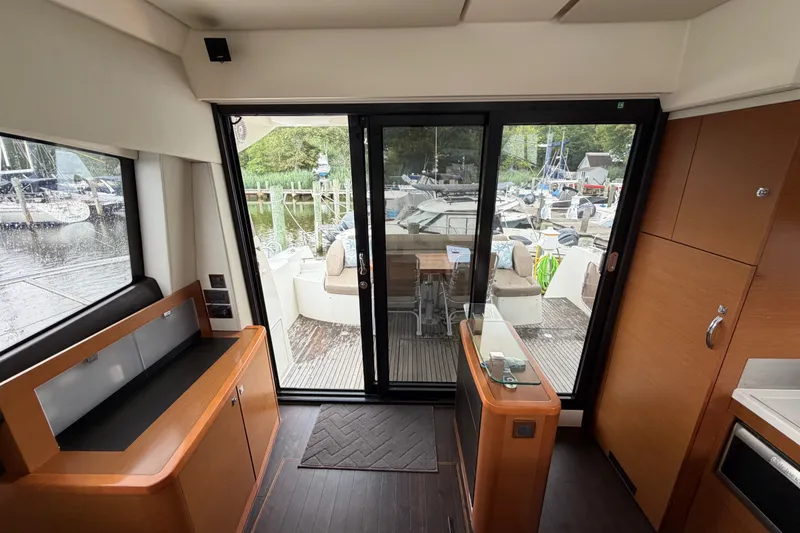 Slide: The Image of Interior view of a 2012 Prestige 500S yacht with sliding glass doors and marina backdrop. - 81