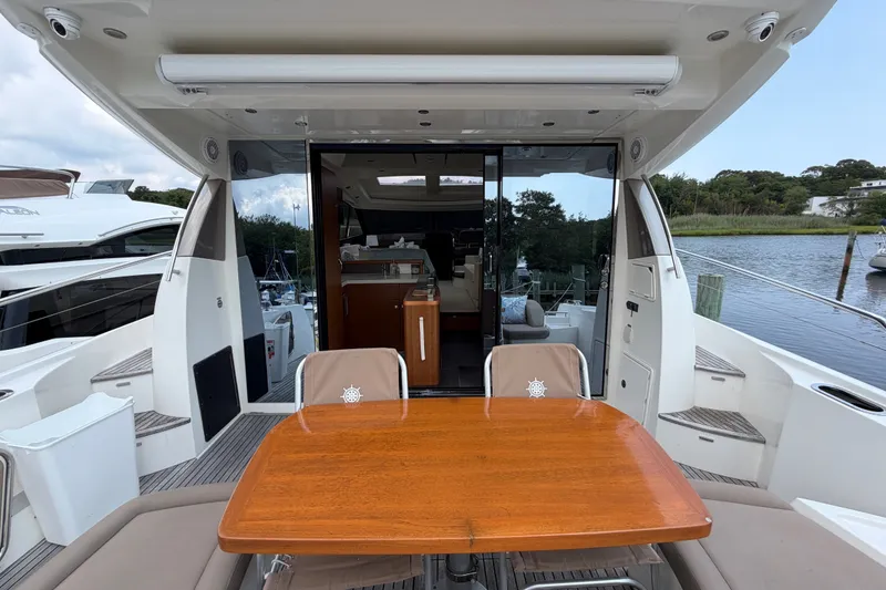 Slide: The Image of Prestige 500S 2012 yacht with outdoor dining area and scenic marina view. - 78