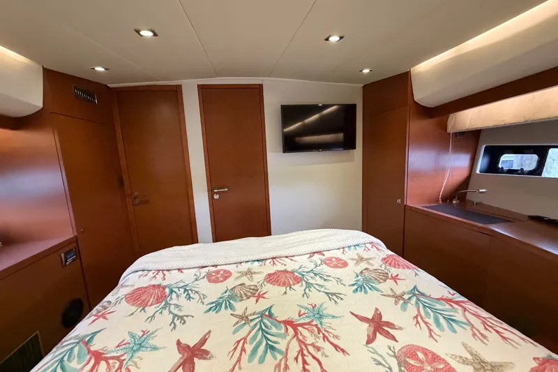 Slide: The Image of Luxurious cabin interior of 2012 Prestige 500S yacht with nautical-themed bedding. - 70