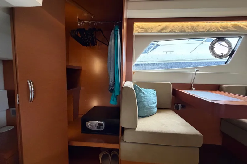 Slide: The Image of Luxurious interior of 2012 Prestige 500S yacht with seating, closet, and window view. - 77