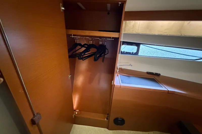 Slide: The Image of Open wooden closet with hangers inside a 2012 Prestige 500S yacht interior. - 73