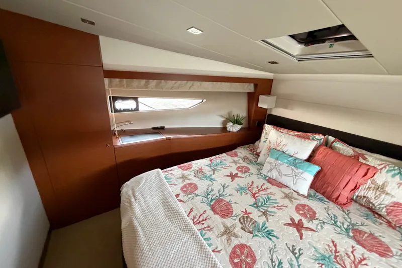 Slide: The Image of Luxurious bedroom interior of 2012 Prestige 500S yacht with nautical-themed bedding. - 30