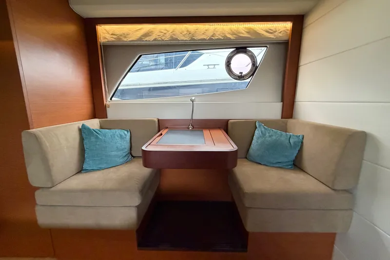 Slide: The Image of Luxurious interior of 2012 Prestige 500S yacht with cozy seating and elegant window view. - 65