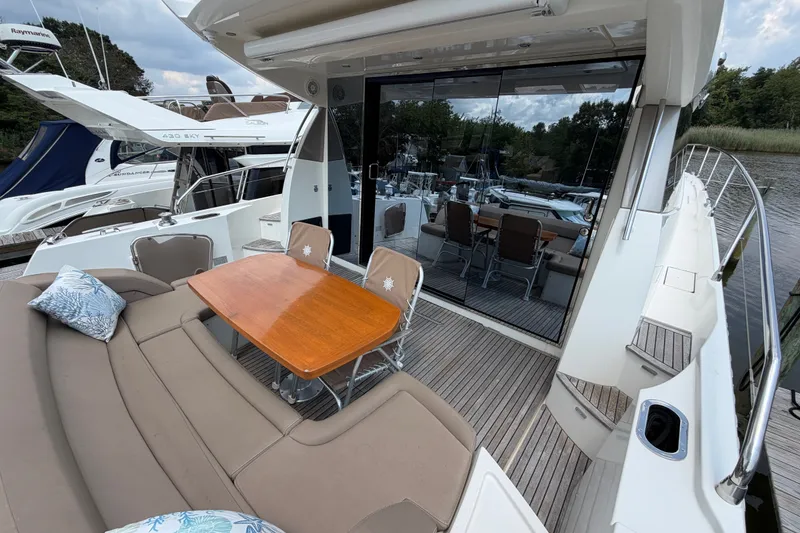 Slide: The Image of Luxury 2012 Prestige 500S yacht with elegant outdoor seating and dining area. - 7