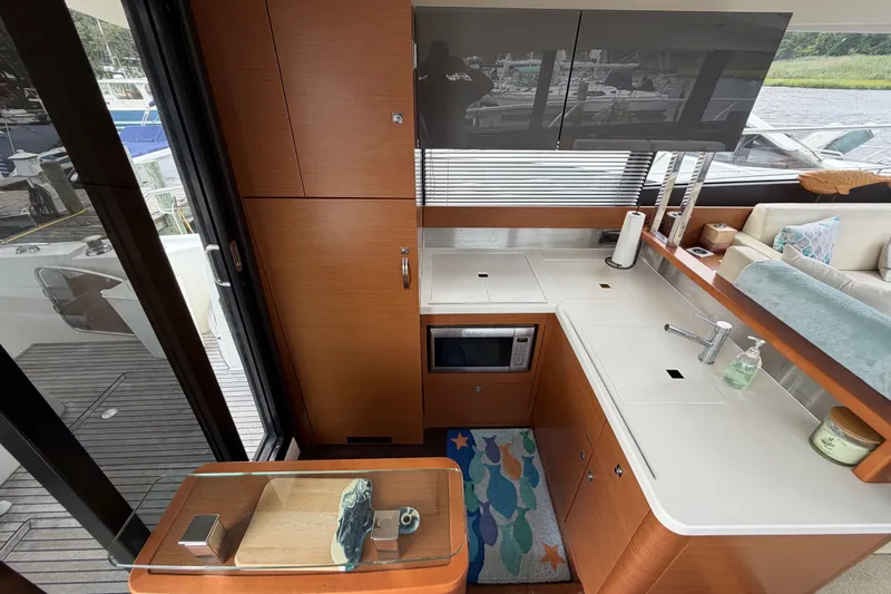 Slide: The Image of Modern kitchen area on a 2012 Prestige 500S yacht, featuring sleek cabinetry and appliances. - 14