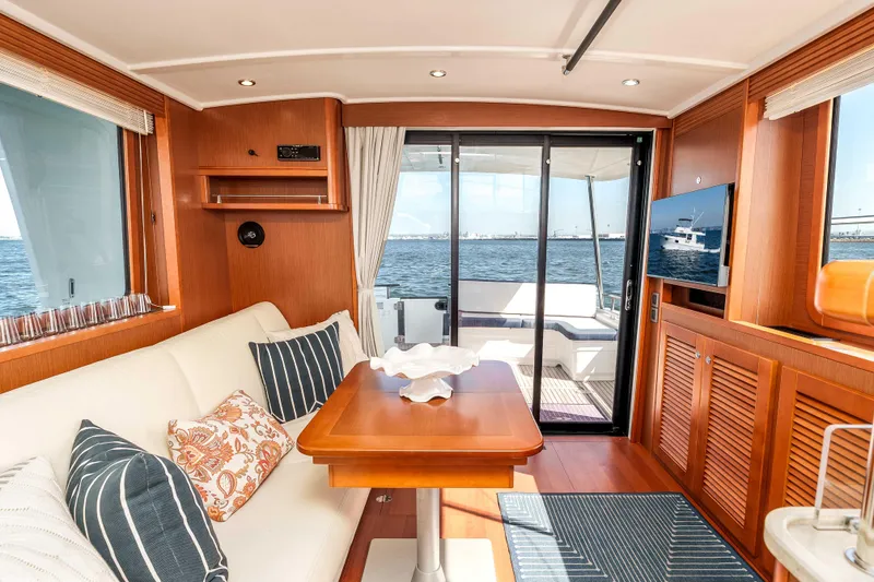 Slide: The Image of Interior of 2019 Beneteau Swift Trawler 44 with elegant wood finish and ocean view. - 16