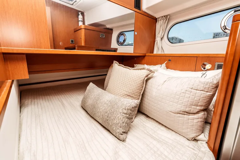 Slide: The Image of Cozy cabin interior of 2019 Beneteau Swift Trawler 44 with plush bedding and wooden accents. - 30