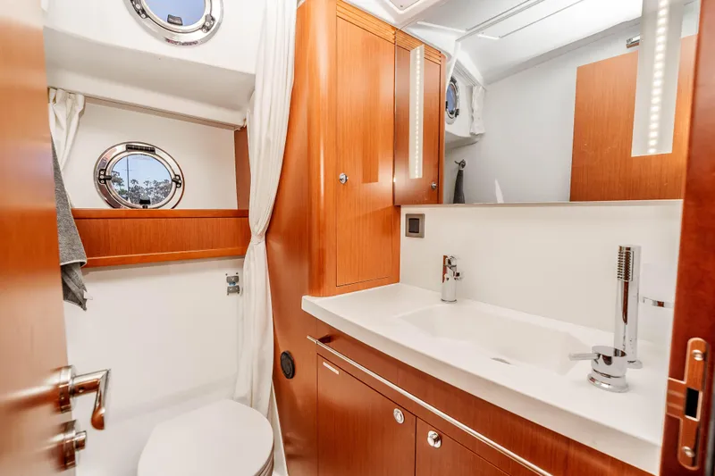 Slide: The Image of Luxurious bathroom interior of 2019 Beneteau Swift Trawler 44 with wood cabinetry and modern fixtures. - 31
