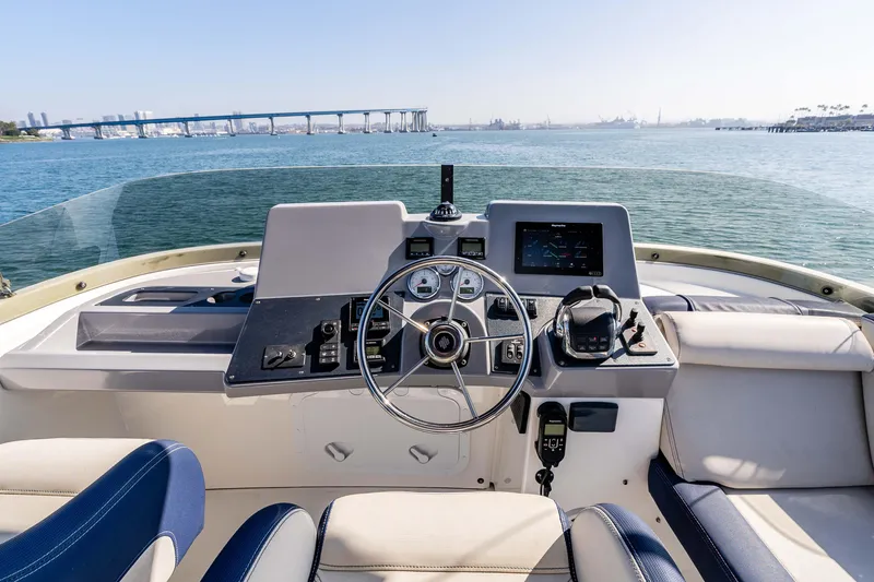 Slide: The Image of Cockpit view of 2019 Beneteau Swift Trawler 44, featuring steering wheel and navigation controls. - 11