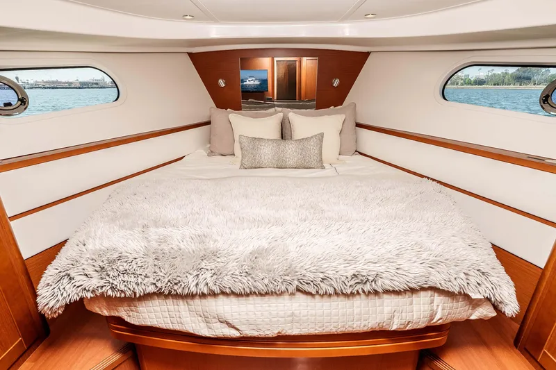 Slide: The Image of Luxurious bedroom interior of 2019 Beneteau Swift Trawler 44 with plush bedding and scenic windows. - 25
