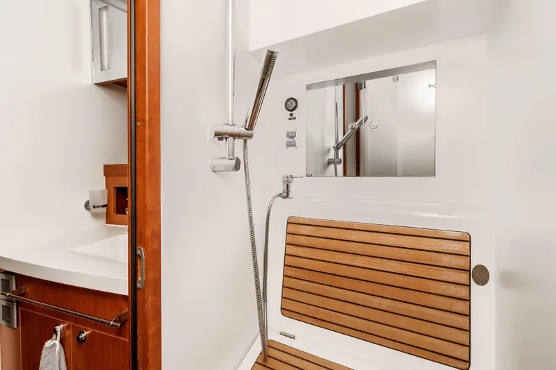 Slide: The Image of Bathroom interior of 2019 Beneteau Swift Trawler 44, featuring wooden accents and modern fixtures. - 28