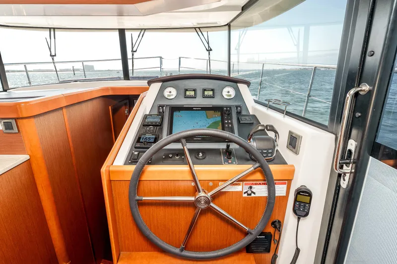 Slide: The Image of Interior helm of 2019 Beneteau Swift Trawler 44 with navigation equipment and steering wheel. - 24