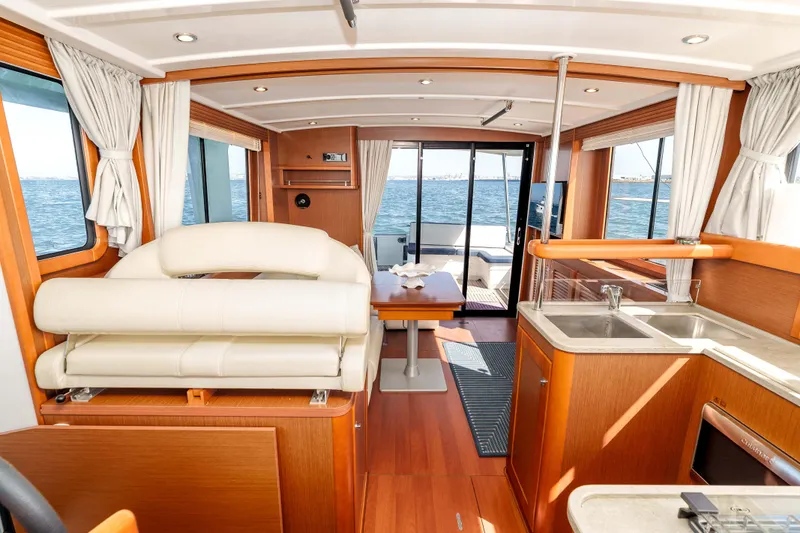 Slide: The Image of Interior of 2019 Beneteau Swift Trawler 44, featuring elegant wood finishes and ocean view. - 23