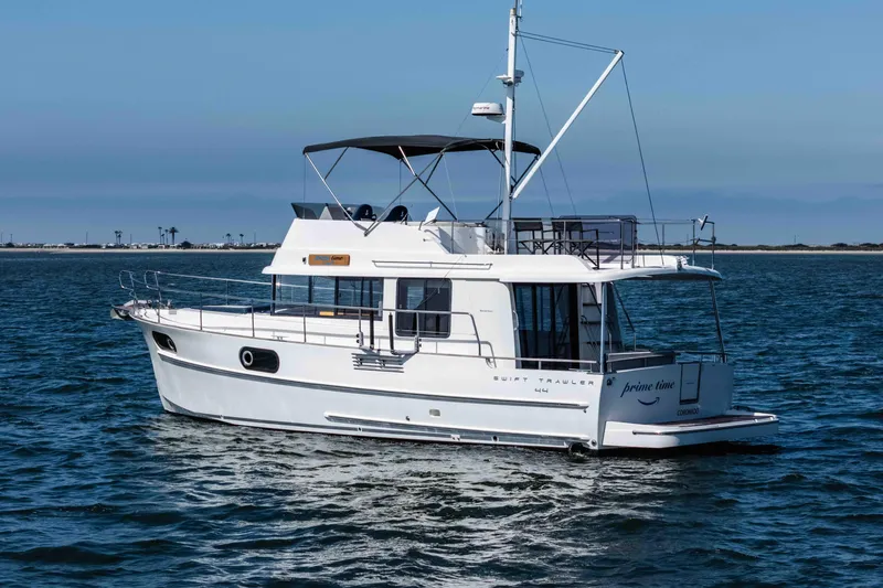 Slide: The Image of 2019 Beneteau Swift Trawler 44 cruising on open water under clear skies. - 5