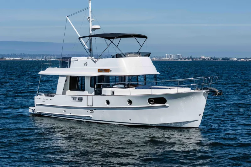 Slide: The Image of 2019 Beneteau Swift Trawler 44 cruising on open water, showcasing sleek design and elegance. - 3