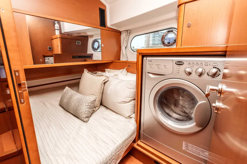 Slide: The Image of 2019 Beneteau Swift Trawler 44 interior with bed and washing machine. - 29