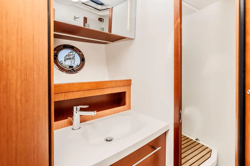 Slide: The Image of 2019 Beneteau Swift Trawler 44 bathroom with modern sink and wooden accents. - 27