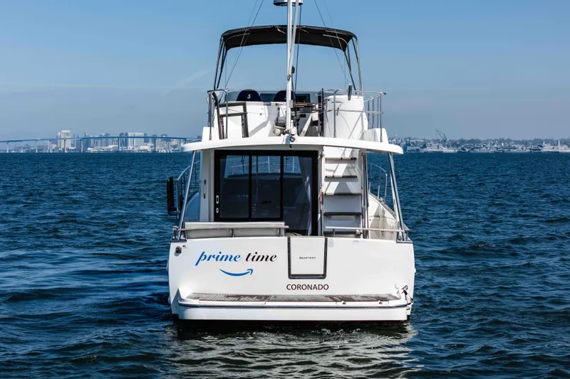 Slide: The Image of 2019 Beneteau Swift Trawler 44 on water, rear view with city skyline. - 4