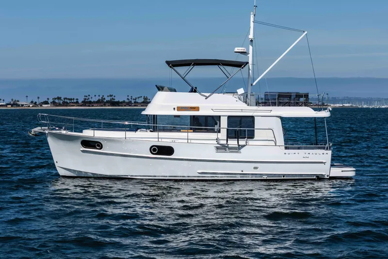 Slide: The Image of 2019 Beneteau Swift Trawler 44 cruising on open water under clear skies. - 6