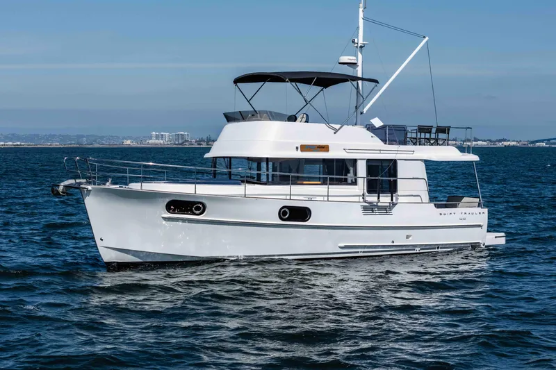 Slide: The Image of 2019 Beneteau Swift Trawler 44 cruising on open water under clear skies. - 7