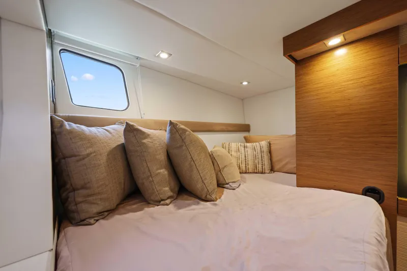 Slide: The Image of Cozy cabin interior of 2016 Cruisers Yachts 45 Cantius with plush bedding and window view. - 53