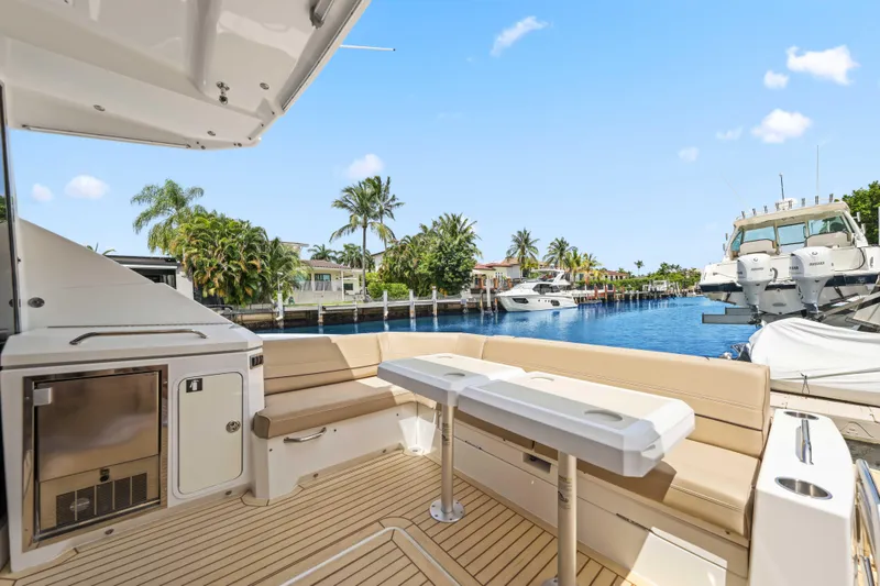 Slide: The Image of Luxurious 2016 Cruisers Yachts 45 Cantius with spacious deck, docked by a scenic waterfront. - 25