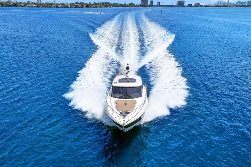 Slide: The Image of 2016 Cruisers Yachts 45 Cantius cruising on clear blue water, leaving a wake trail. - 7