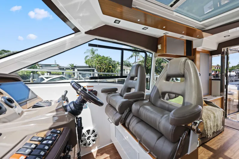 Slide: The Image of Interior of 2016 Cruisers Yachts 45 Cantius with luxurious helm seating and modern controls. - 41