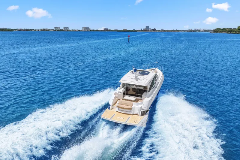 Slide: The Image of 2016 Cruisers Yachts 45 Cantius cruising on open blue water, leaving a wake behind. - 14